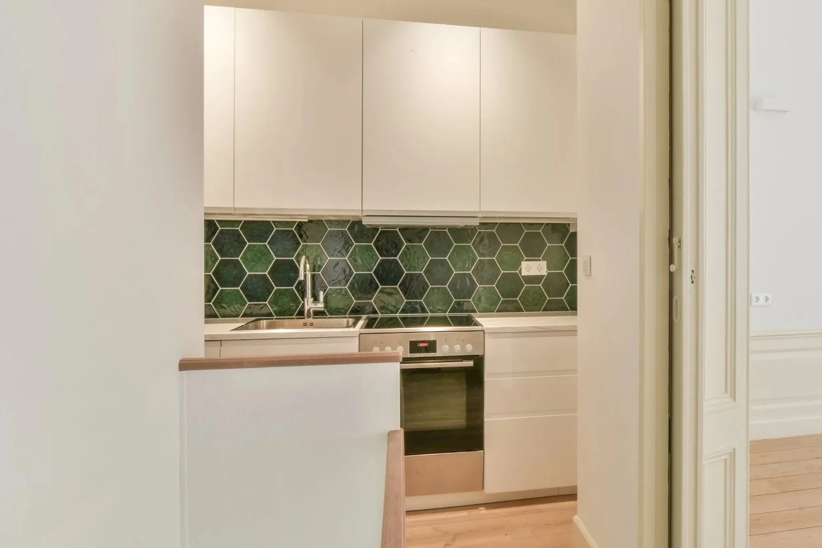 Hallway with wallcovering near kitchen